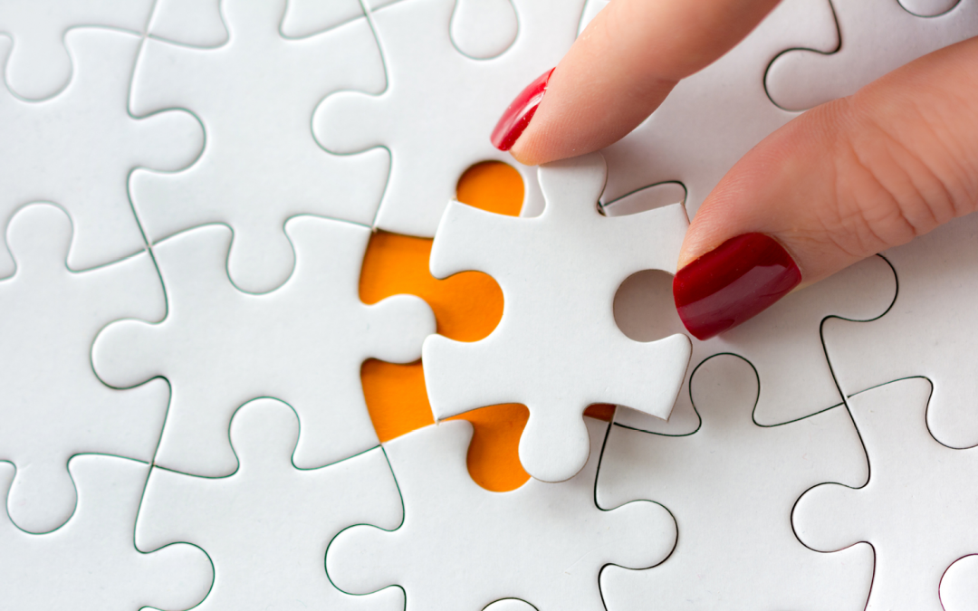 Mature woman putting in last puzzle piece