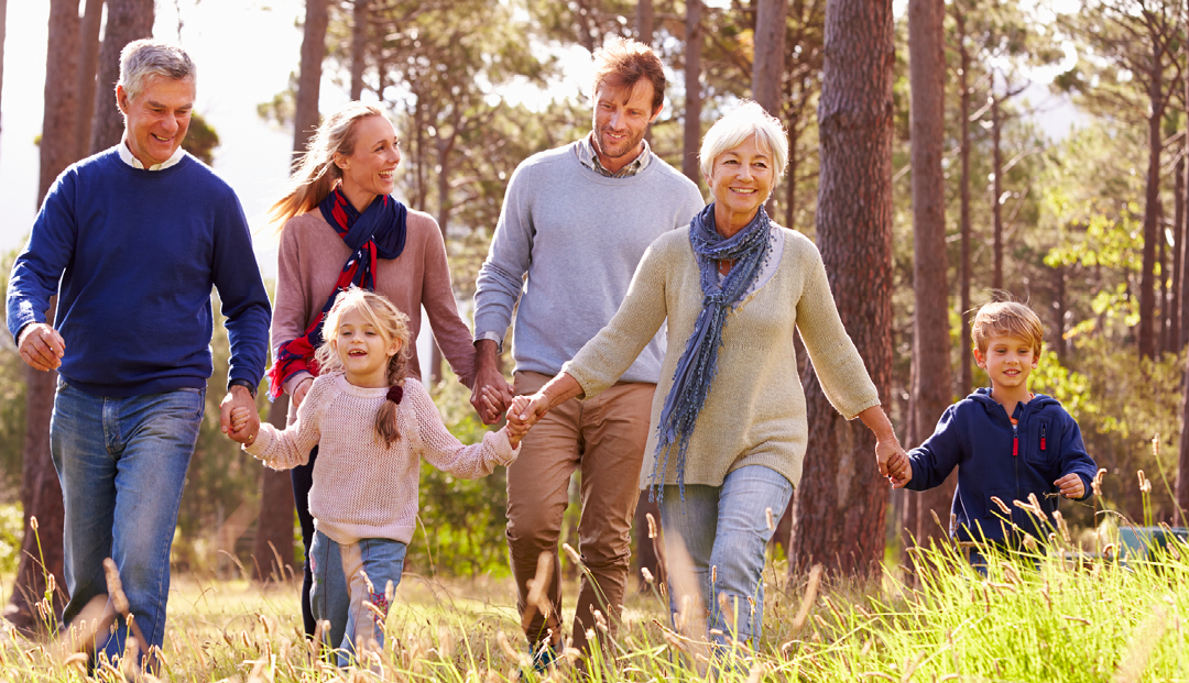 multi-generation family walking through field