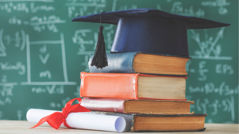 Graduation cap sitting on pile of books