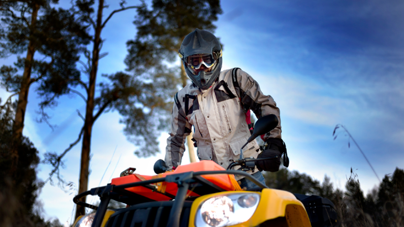 man leaning on ATV