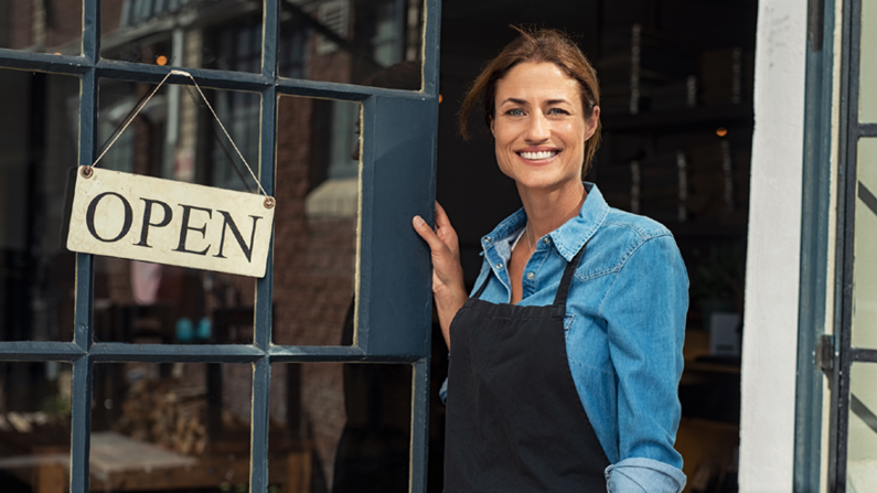 woman in front of business open sign