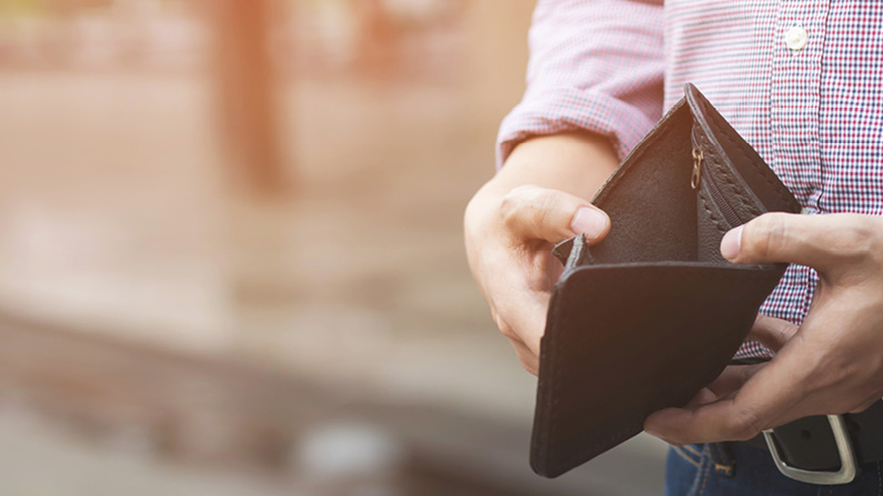 Man holding empty wallet