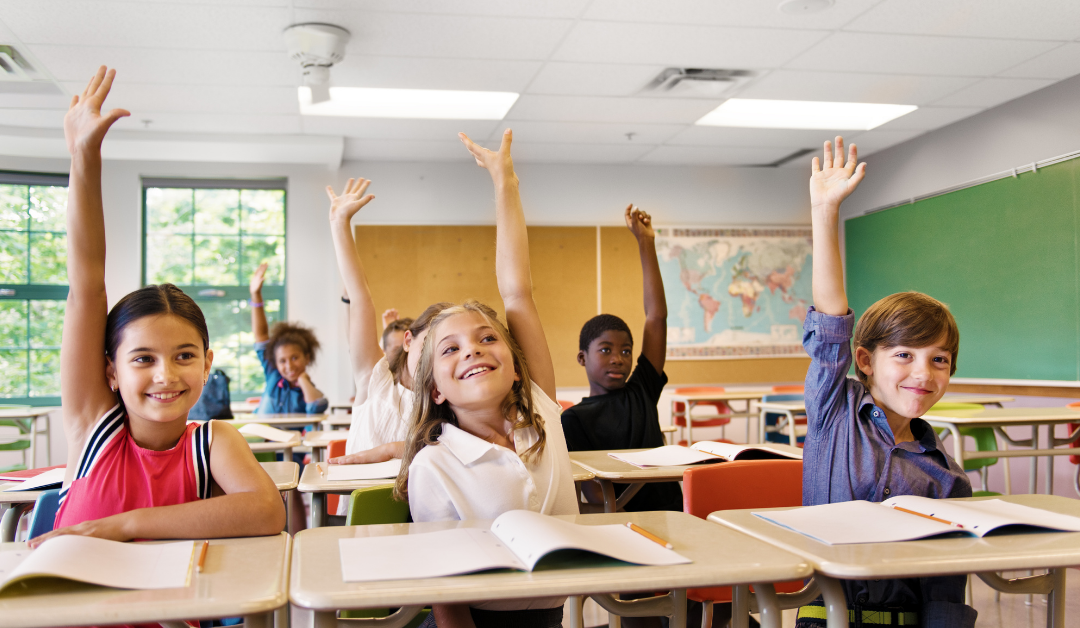 Children sitting in desks in classroom