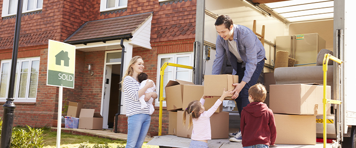 Dad handing daughter moving box