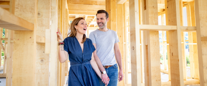 Wife and husband looking at home under construction