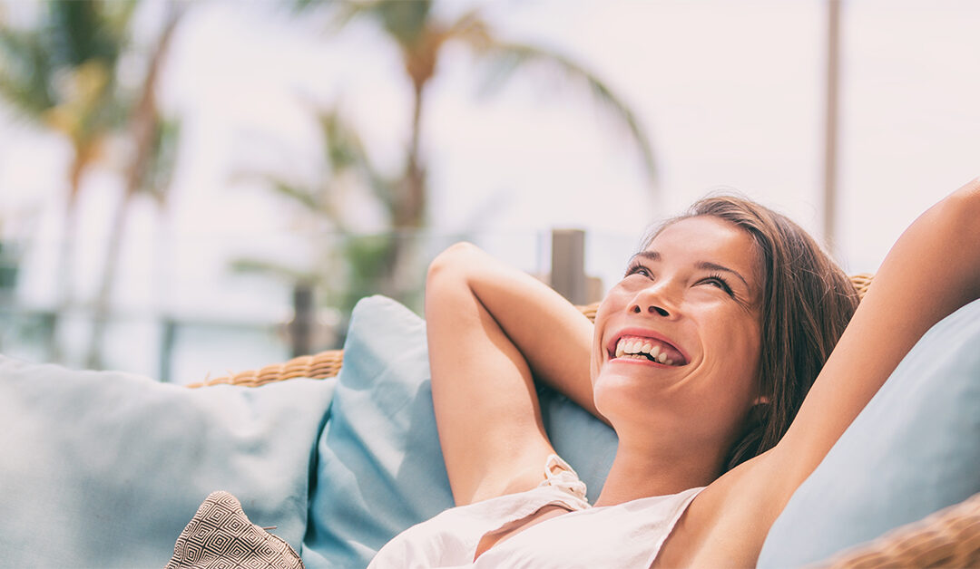 Woman with hands behind head, relaxing