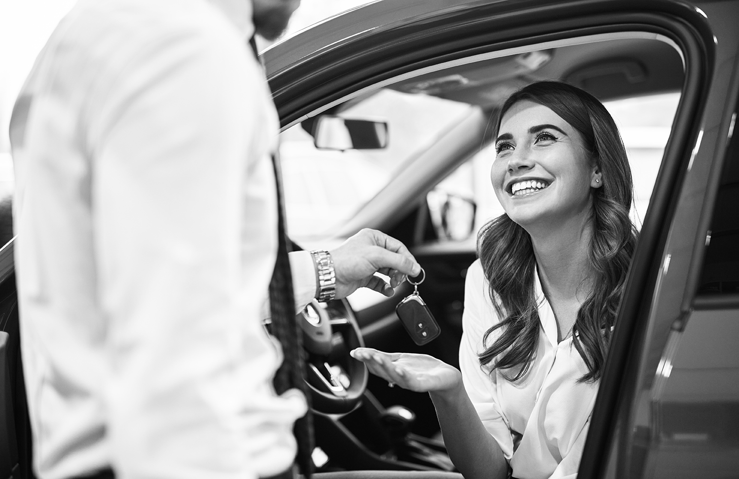 Dealer giving keys to happy customer